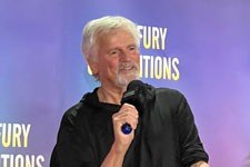 Richard Dean Anderson holding a microphone at Starfury Ascension